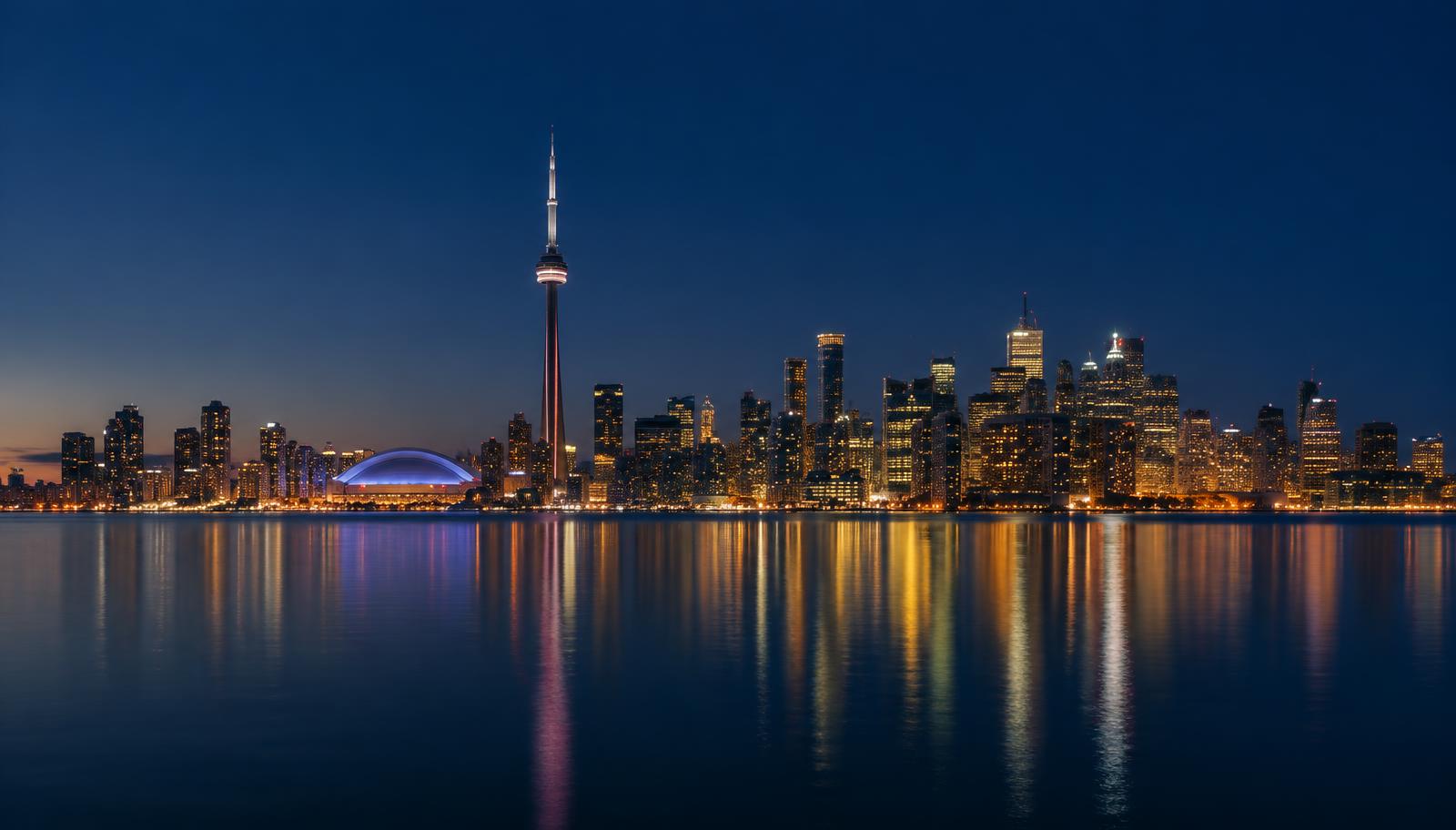 Toronto skyline at dusk with the CN Tower over Lake Ontario